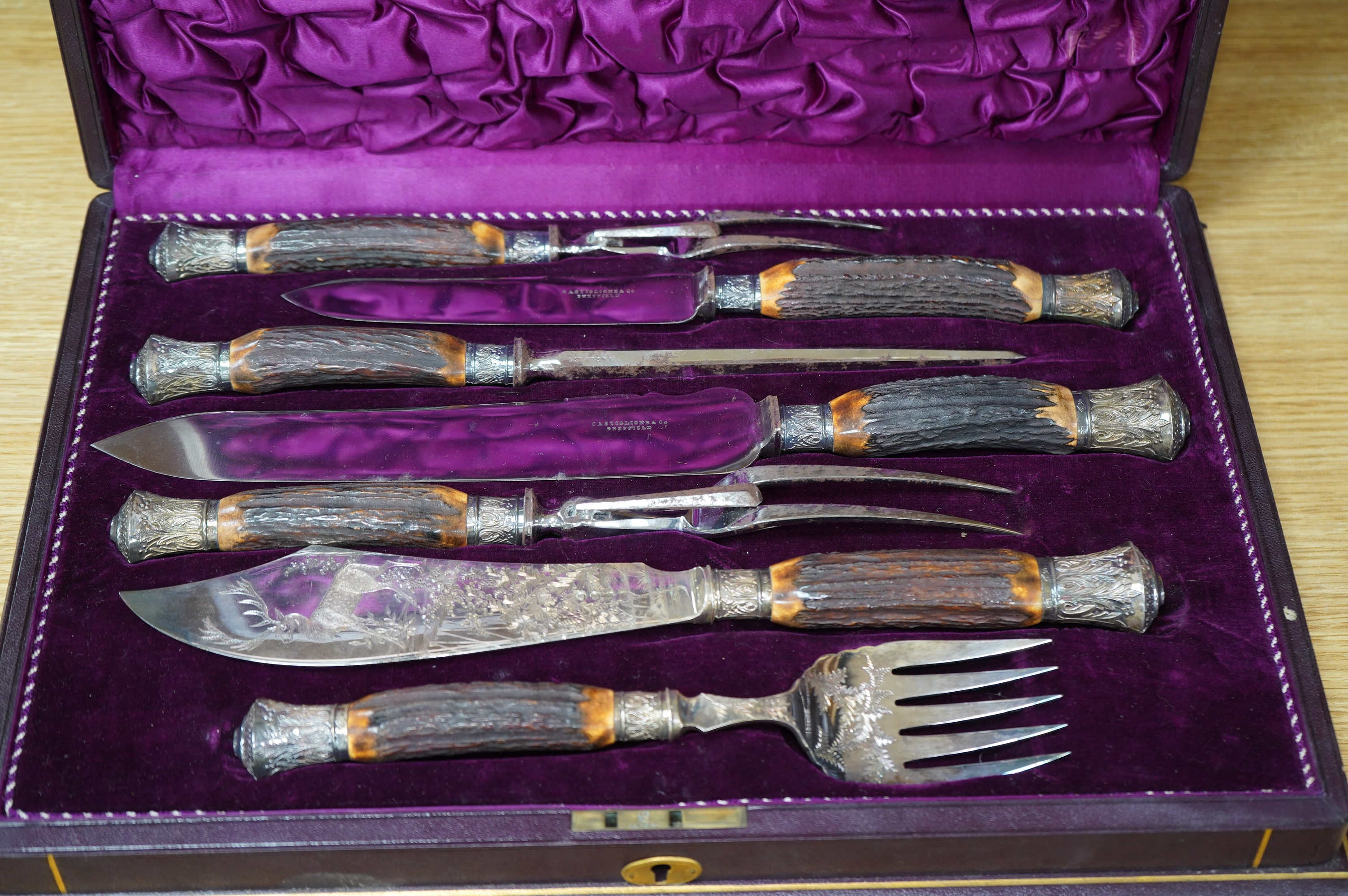 A gilt tooled leather cased stag handled silver collared carving set, case 44cm wide. Condition - good